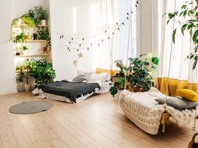 clean white room with plants and boho furniture 