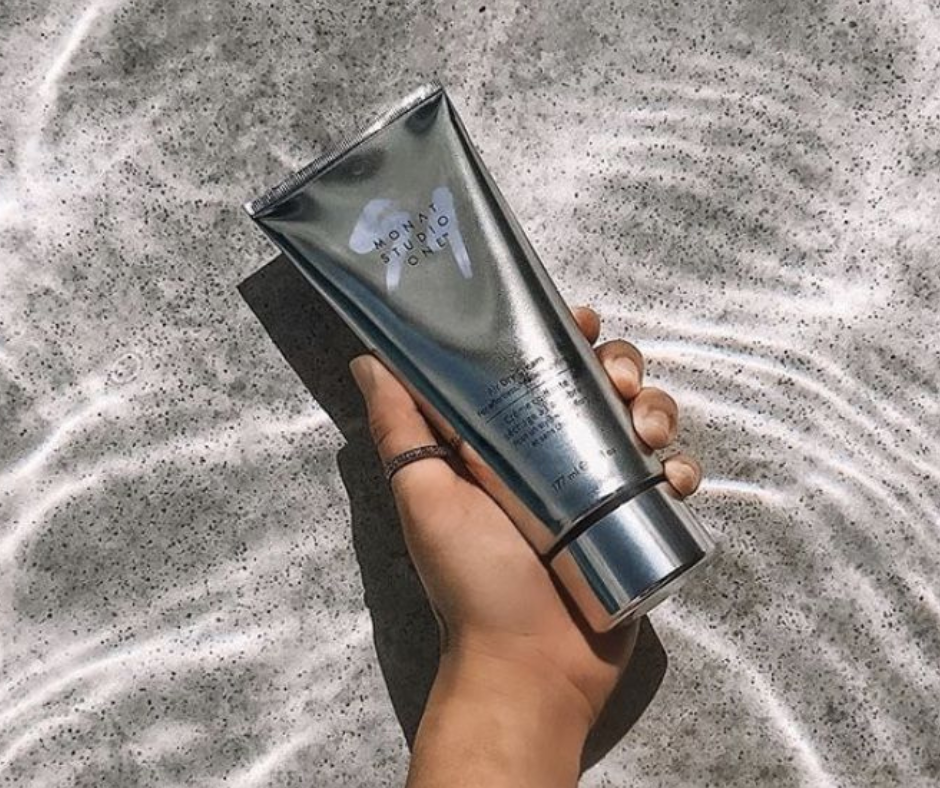 monat air dry cream bottle held above water