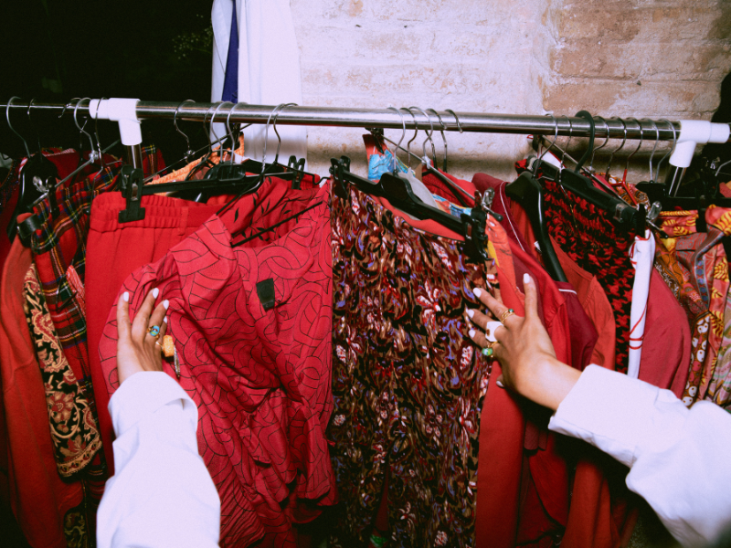 thrift store clothing rack of reds